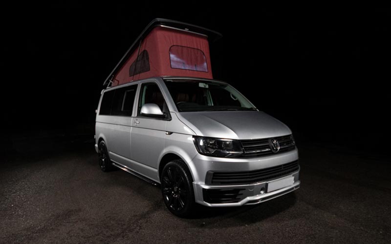 Silver VW Transporter with pop top roof